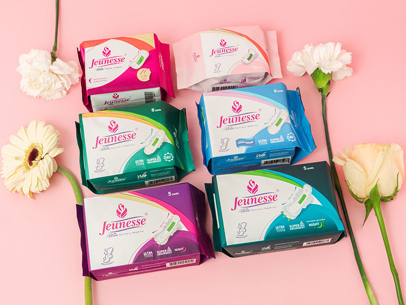 The full range of Jeunesse Anion pads and panty liners styled with fresh flowers